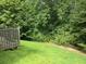 Backyard view with wooden deck surrounded by lush green trees at 4368 Rocky View Dr, Forest Park, GA 30297