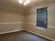 Tranquil bedroom featuring neutral walls, carpeted floor, and a window for natural light, creating a peaceful retreat at 4368 Rocky View Dr, Forest Park, GA 30297