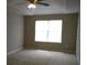 Serene bedroom with plush carpet, a ceiling fan, and a bright window offering a calming living space at 4368 Rocky View Dr, Forest Park, GA 30297