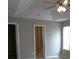 Cozy bedroom featuring a ceiling fan, soft carpet, and neutral walls with a view into an adjoining bath or closet area at 4368 Rocky View Dr, Forest Park, GA 30297