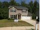 Charming two-story home with a well-maintained lawn and a two car garage in a residential neighborhood at 4368 Rocky View Dr, Forest Park, GA 30297