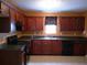 Well-equipped kitchen boasting dark wood cabinets, modern appliances, and plenty of counter space at 4368 Rocky View Dr, Forest Park, GA 30297