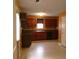 Functional kitchen featuring dark cabinets, tile floors, modern appliances, and ample counter space for cooking ease at 4368 Rocky View Dr, Forest Park, GA 30297