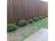 Green backyard with shrubbery and wooden fence at 101 Dewey Rd, Lilburn, GA 30047
