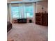 Well-lit bedroom featuring a large window, stylish curtains, wooden furniture, and soft carpeting at 101 Dewey Rd, Lilburn, GA 30047