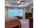 Bright bedroom featuring a king bed, large windows, curtains, wooden furniture, and a ceiling fan at 101 Dewey Rd, Lilburn, GA 30047