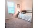 Cozy bedroom with a large window providing natural light and plush carpet at 101 Dewey Rd, Lilburn, GA 30047
