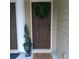 Charming front door with a seasonal wreath, a welcome mat, and a decorative plant at 101 Dewey Rd, Lilburn, GA 30047