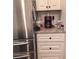 Kitchen details featuring a stainless steel refrigerator and white cabinetry for storage at 101 Dewey Rd, Lilburn, GA 30047