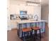 Modern kitchen featuring a unique island with a sink, granite countertops, and stainless steel appliances at 101 Dewey Rd, Lilburn, GA 30047