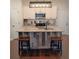 Modern kitchen featuring a unique island with a sink, granite countertops, and stainless steel appliances at 101 Dewey Rd, Lilburn, GA 30047