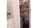 Spacious pantry with wire shelving fully stocked with a variety of food items and a trash can at 101 Dewey Rd, Lilburn, GA 30047