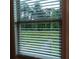 Window with blinds looking out to green backyard at 101 Dewey Rd, Lilburn, GA 30047