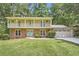 Charming two-story home with a brick facade, upper porch, and a well-manicured lawn at 1080 Northshore Dr, Roswell, GA 30076