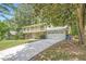 A lovely home with a large driveway, two-car garage, and a second-story balcony surrounded by trees at 1080 Northshore Dr, Roswell, GA 30076