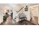 Welcoming foyer with hardwood floors, staircase, and black bench at 1080 Northshore Dr, Roswell, GA 30076