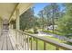 View from covered porch of a beautifully landscaped front yard with mature trees and driveway at 1080 Northshore Dr, Roswell, GA 30076