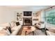 Inviting living room with a cozy fireplace, built-in shelves, and large windows at 1080 Northshore Dr, Roswell, GA 30076