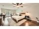 Spacious main bedroom with a king bed, hardwood floors, and a ceiling fan at 1080 Northshore Dr, Roswell, GA 30076