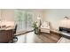Bright home office featuring hardwood floors, a work space, a chair, and a door to the exterior at 1080 Northshore Dr, Roswell, GA 30076