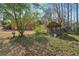 Landscaped backyard with a charming wooden gazebo and lots of trees in background at 1420 Arblay Pl, Loganville, GA 30052