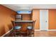 Basement bar area featuring bar top with stools, fridge, and lighting at 1420 Arblay Pl, Loganville, GA 30052