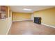 Finished basement with laminate flooring, lighting and fireplace at 1420 Arblay Pl, Loganville, GA 30052
