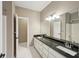 Bathroom featuring double sinks, granite countertops, and a large mirror over the vanity at 1420 Arblay Pl, Loganville, GA 30052