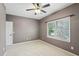 Bedroom featuring neutral carpet, window, baseboard, and gray walls at 1420 Arblay Pl, Loganville, GA 30052