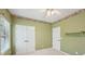 Neutral bedroom with decorative border, ceiling fan, and double door closet at 1420 Arblay Pl, Loganville, GA 30052