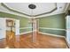 Dining room features beautiful hardwood floors, elegant chandelier, and detailed trim, ready for gatherings at 1420 Arblay Pl, Loganville, GA 30052