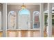 Bright foyer featuring hardwood floors, arched windows, and decorative columns create an elegant entrance at 1420 Arblay Pl, Loganville, GA 30052
