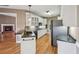 Eat-in kitchen features stainless steel appliances, granite countertops, white cabinets, and opens to the living room at 1420 Arblay Pl, Loganville, GA 30052