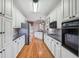 Modern kitchen with white cabinets, granite countertops, and stainless steel appliances, offering style and functionality at 1420 Arblay Pl, Loganville, GA 30052