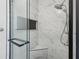 Luxurious shower with glass door, updated tile, and rainfall showerhead at 1420 Arblay Pl, Loganville, GA 30052