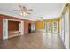 Bright sunroom with large windows, ceiling fans, and vintage black cabinet with custom painting at 1420 Arblay Pl, Loganville, GA 30052