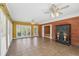 Sunroom with brick accent wall, tile floors, and lots of windows that fill the home with natural light at 1420 Arblay Pl, Loganville, GA 30052