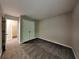 Comfortable bedroom featuring neutral walls, soft carpeting, and a roomy closet with bright lighting at 2001 Fairbrook Ln, Woodstock, GA 30189