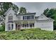 Charming two-story home with a covered front porch and well-maintained landscaping at 2001 Fairbrook Ln, Woodstock, GA 30189