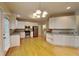 Spacious kitchen with stainless steel appliances, white cabinets, and wooden floors at 2001 Fairbrook Ln, Woodstock, GA 30189
