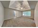 Expansive main bedroom with tray ceiling, ceiling fan, and carpeting at 2001 Fairbrook Ln, Woodstock, GA 30189