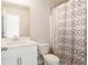 Neutral bathroom with geometric shower curtain, white vanity, and classic fixtures at 2622 Running River Ct, Lawrenceville, GA 30045