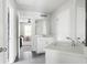 Well-lit bathroom featuring sleek gray tile floors, modern fixtures, and a partial view into an adjacent bedroom at 2622 Running River Ct, Lawrenceville, GA 30045