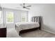Clean bedroom featuring bright windows, neutral color palette, and ceiling fan at 2622 Running River Ct, Lawrenceville, GA 30045