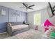 Cozy bedroom showcases a light blue accent wall, a daybed, and a bright window at 2622 Running River Ct, Lawrenceville, GA 30045