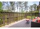 Deck with wood flooring, seating, and a wood fence overlooking the wooded yard at 2622 Running River Ct, Lawrenceville, GA 30045