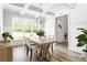 Bright dining room with chandelier, wooden floors, and a large window at 2622 Running River Ct, Lawrenceville, GA 30045