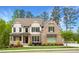 Charming two-story home featuring a brick facade, well-manicured lawn, and inviting front porch at 2622 Running River Ct, Lawrenceville, GA 30045