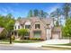Beautiful home showcasing brick and siding exterior, attached garage, and professionally landscaped yard at 2622 Running River Ct, Lawrenceville, GA 30045