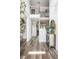 Bright foyer with beautiful staircase, wood flooring, and stylish console table with mirror at 2622 Running River Ct, Lawrenceville, GA 30045